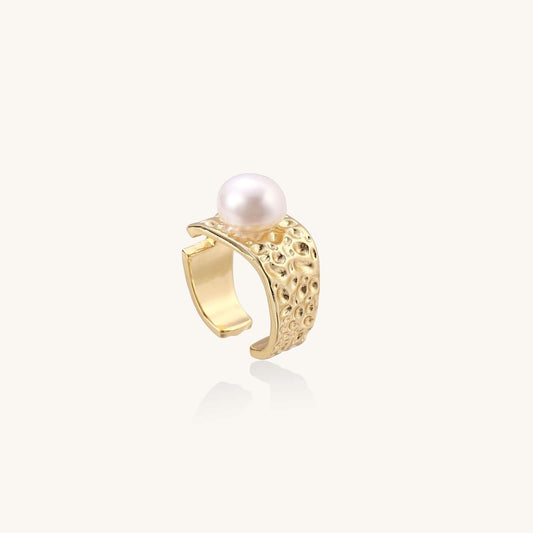 Golden Tide Pearl Ring showcasing a hammered gold band with a freshwater pearl on a light background.