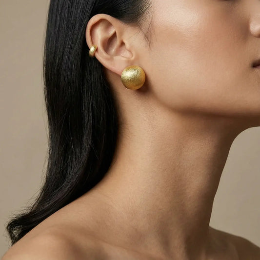 Brushed Gold Dome Clips earrings showcased on a model, highlighting the brushed-satin finish and elegant design.