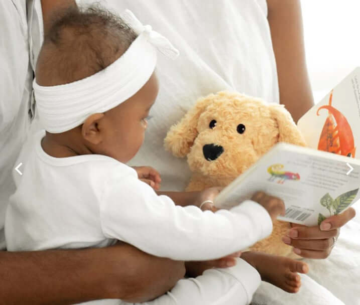 Golden Dog Plush Warmies Soothing Therapy with baby enjoying story time