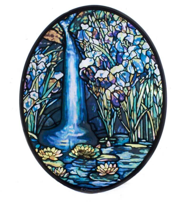 A stained glass window replica featuring a flowing waterfall motif with vibrant blue colors and floral elements, crafted in an oval shape.