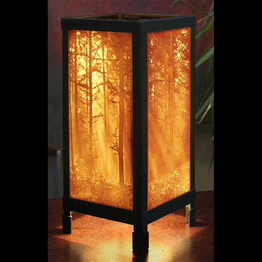 Woodland Sunbeams Luminaire Tabletop Lamp illuminating with a beautiful forest design in warm light.