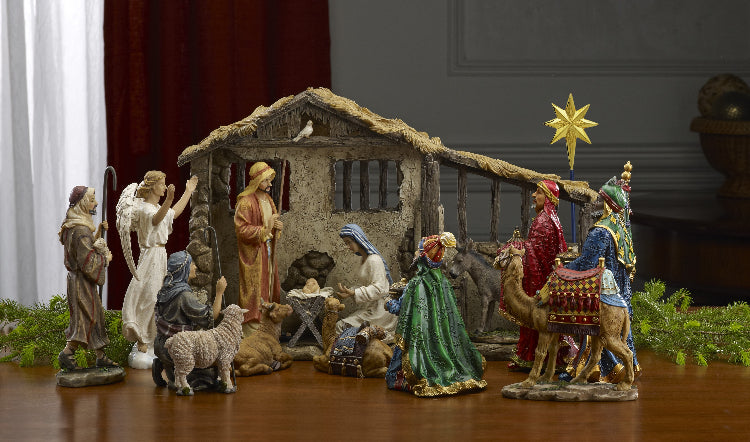 A 7-inch tall nativity set featuring detailed figures of the Holy Family, the three kings, shepherds, an angel, animals, and a stable with integrated lighting.