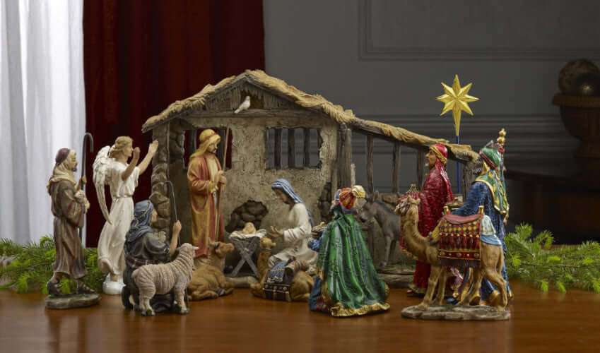 A 14-inch tall nativity set featuring The Holy Family, The Shepherds, The Three Kings with gifts, an angel, and a four-piece animal set in front of a lighted stable.