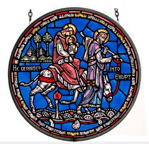 Stained glass window depicting the Flight into Egypt, featuring figures on horseback against a blue background with a cityscape.