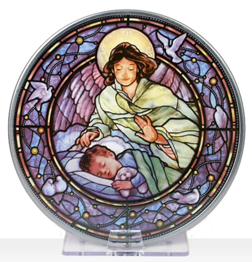 A round stained glass window featuring a depiction of a guardian angel above a sleeping boy, with a predominantly purple and blue color palette.