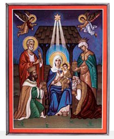 A stained glass window depicting the nativity scene with Mary, Joseph, baby Jesus, and the angelic figures in a stable setting with a bright star above.
