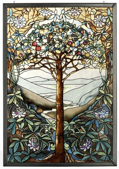Stained glass window panel featuring the Tree of Life design with a central tree surrounded by floral patterns and a representation of a meadow.