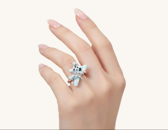Hand wearing a Dreamy Panda Flower Ring, showcasing its kawaii panda design and soft blue enamel.