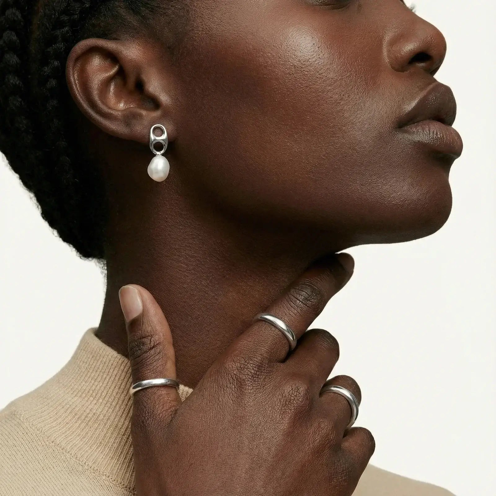Model wearing Pearl Circle Drop Studs earrings with silver geometric design and pearl detail.