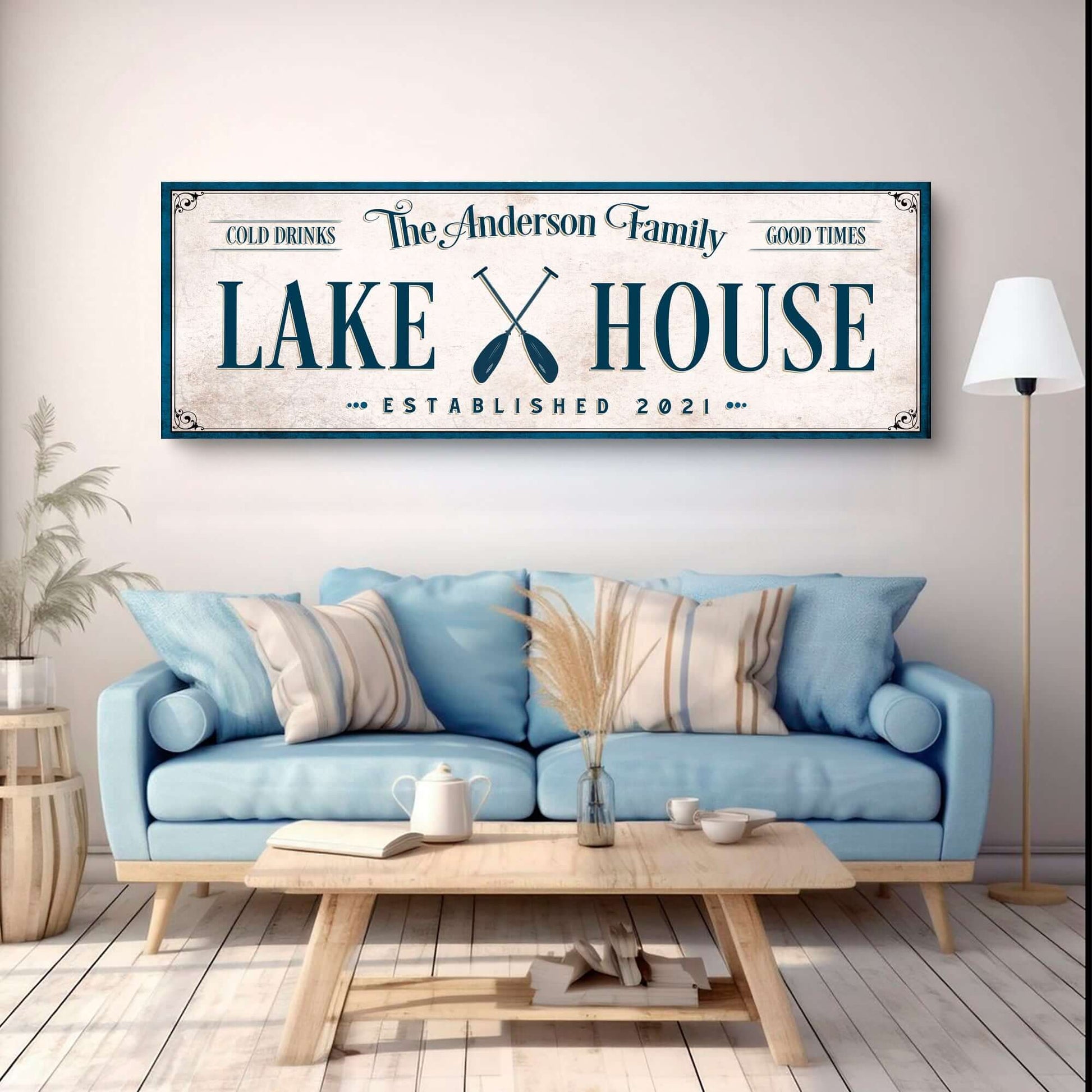 Personalized Lake House Sign IV displayed above a cozy couch in a stylish interior setting.