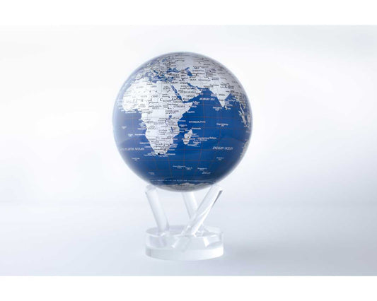 A rotating globe with silver landmasses on a blue background, set on a clear stand, demonstrating ambient light-powered technology.