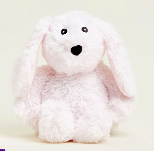 A pink plush bunny-shaped warmie with a face printed on its side, designed for microwave and freezer use.