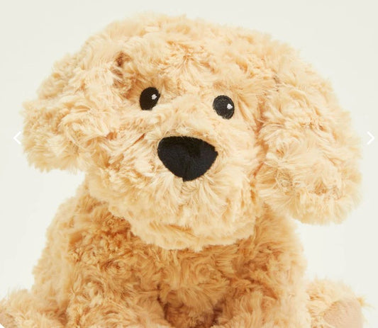 A plush toy resembling a golden dog with a soft, fluffy texture, seated upright.