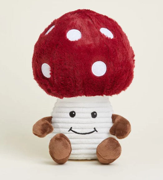 A plush toy resembling a smiling mushroom with a red cap, white stem, and brown spots.