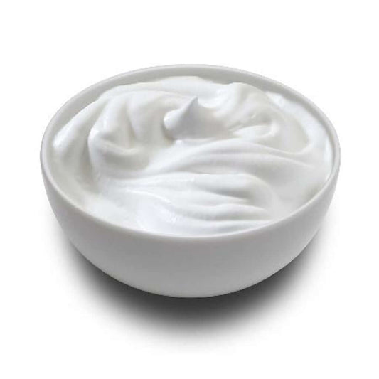 A bowl of crème fraîche, French cultured cream, displayed on a white background.