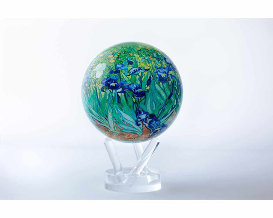 A rotating globe featuring the 'Irises' painting by Van Gogh with a field of purple and white flowers and a golden field in the background, set on a clear stand.