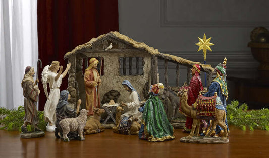 A 7-inch tall nativity set featuring detailed figures of the Holy Family, the three kings, shepherds, an angel, animals, and a stable with integrated lighting.