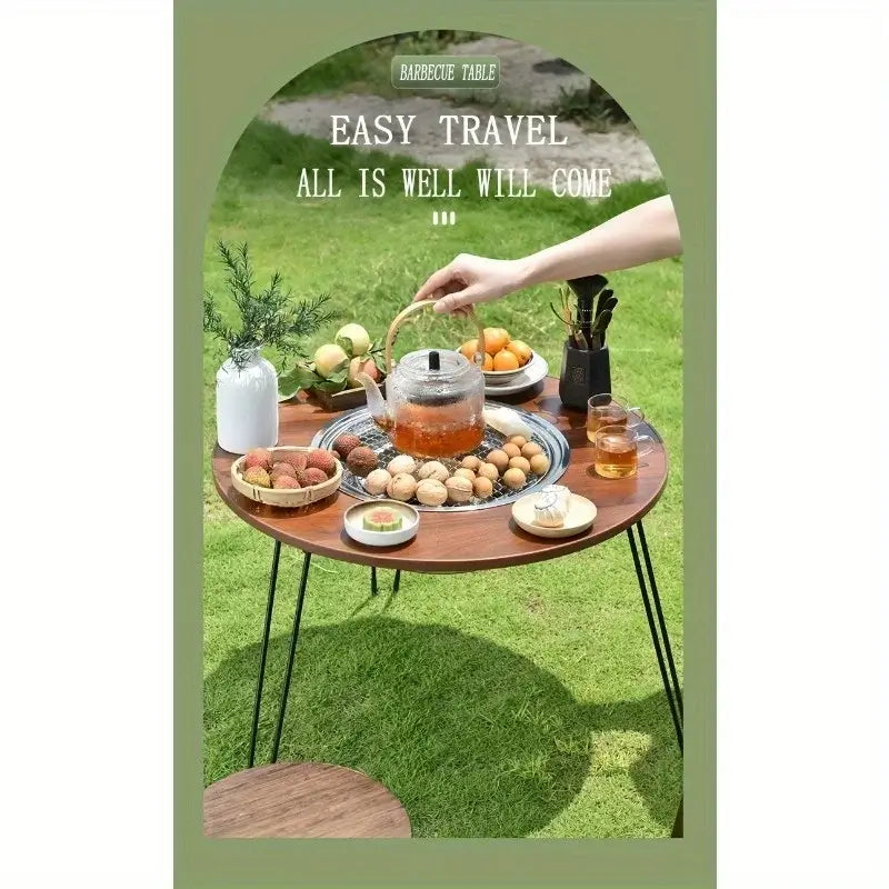 1 Portable Folding Stove Table Camping Round Table for Barbecue Outdoor Picnics Sports Outdoor Barbecue Table set up outdoors with food.