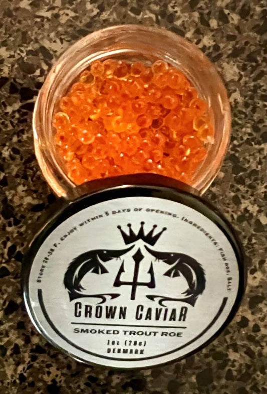 A tin can labeled 'Crown Caviar Smoked Trout Roe' with a graphic of a trident and fish, indicating the product is a gourmet delicacy.