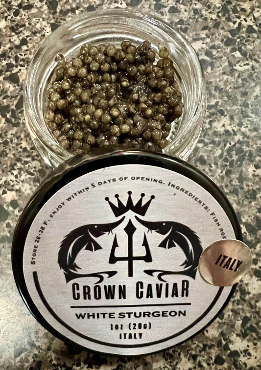 A tin can label of Crown Caviar's White Sturgeon caviar with the product name, weight of 1 oz (28g), and the origin 'Italy' highlighted.