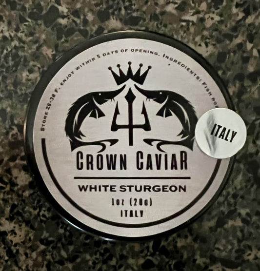 A tin can label of Crown Caviar's White Sturgeon caviar with the product name, weight of 1 oz (28g), and the origin 'Italy' highlighted.