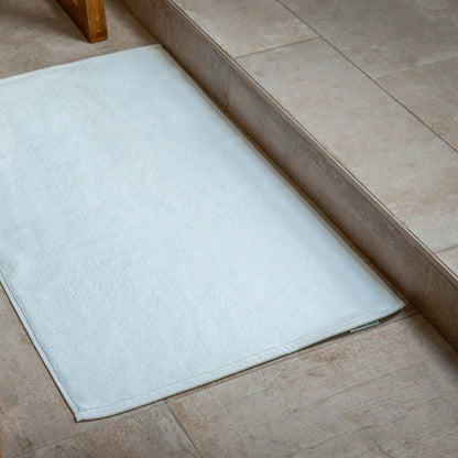 Luxury Organic Bath Mats placed elegantly near a bathroom entrance, showcasing its soft texture and eco-friendly design.