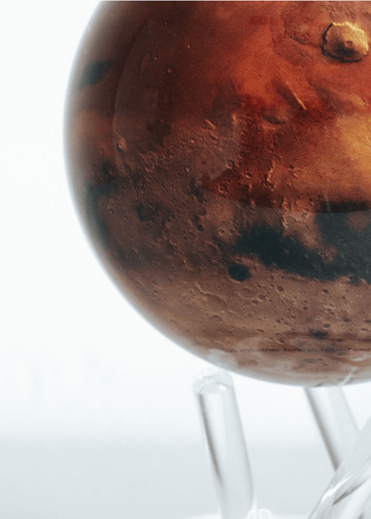 A rotating globe of Planet Mars, powered by ambient light, displayed against a white background.
