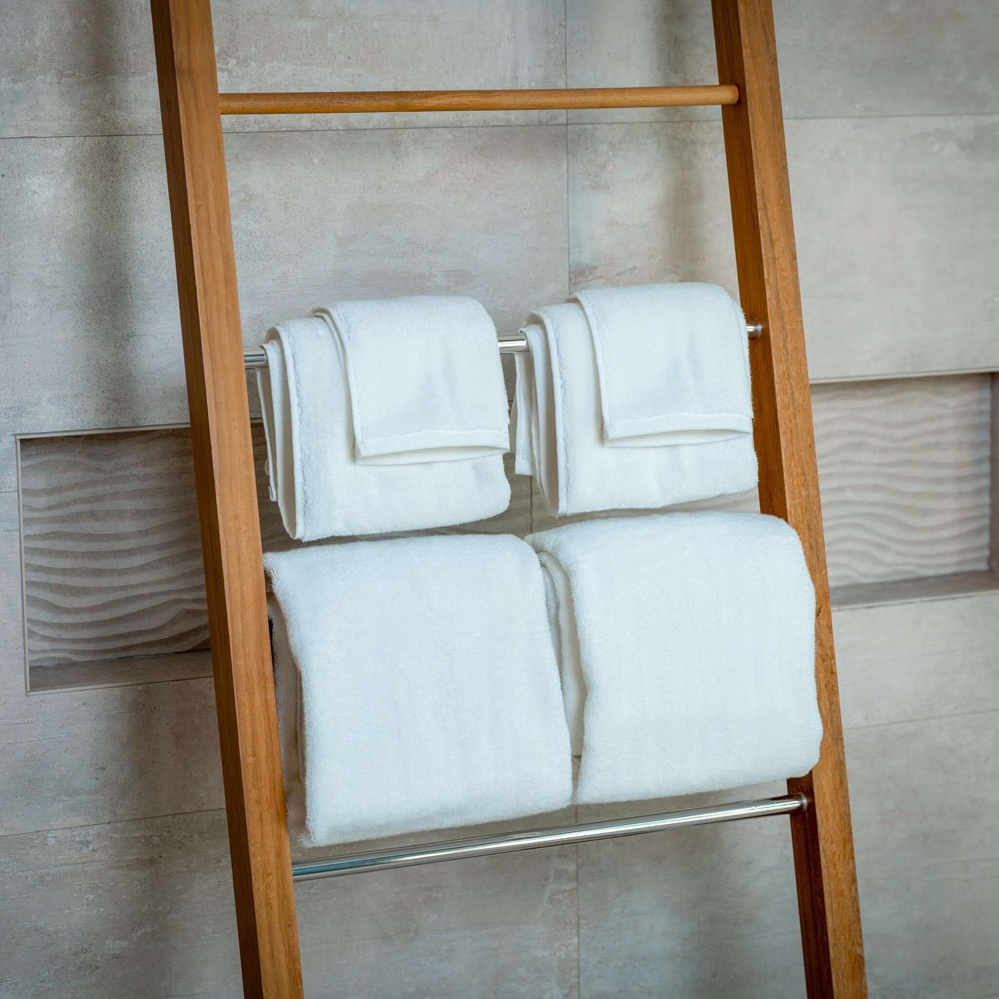 Luxury Organic Bath Towel Set 6 pcs arranged on a wooden ladder, showcasing soft and plush eco-friendly towels.
