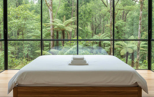 Eucalyptus silk sheets set stacked on a wooden surface, showcasing the ultra-soft and breathable fabric.