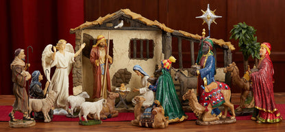 A complete 14 inch Real Life Nativity Set including figures of Mary, Joseph, baby Jesus, the three Wise Men, a camel, two sheep, and a palm tree, with the Christmas star above.