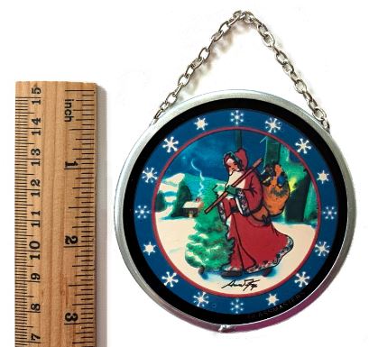 A round stained glass ornament featuring an illustration of Santa Claus with a Christmas tree, snowflakes, and a vintage winter scene.