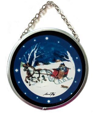 A 3-inch round stained glass Christmas ornament featuring a vintage sleigh ride scene with a blue background, silhouettes of a horse and sleigh, and artist signature at the bottom.